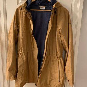 Lined waterproof rain jacket in tobacco brown with navy blue lining